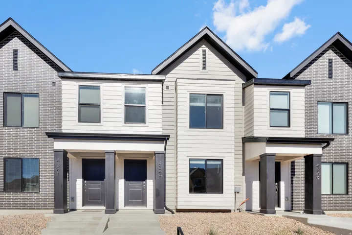 Contemporary exterior featuring mixed material facades, pitched roofs, and covered entryways