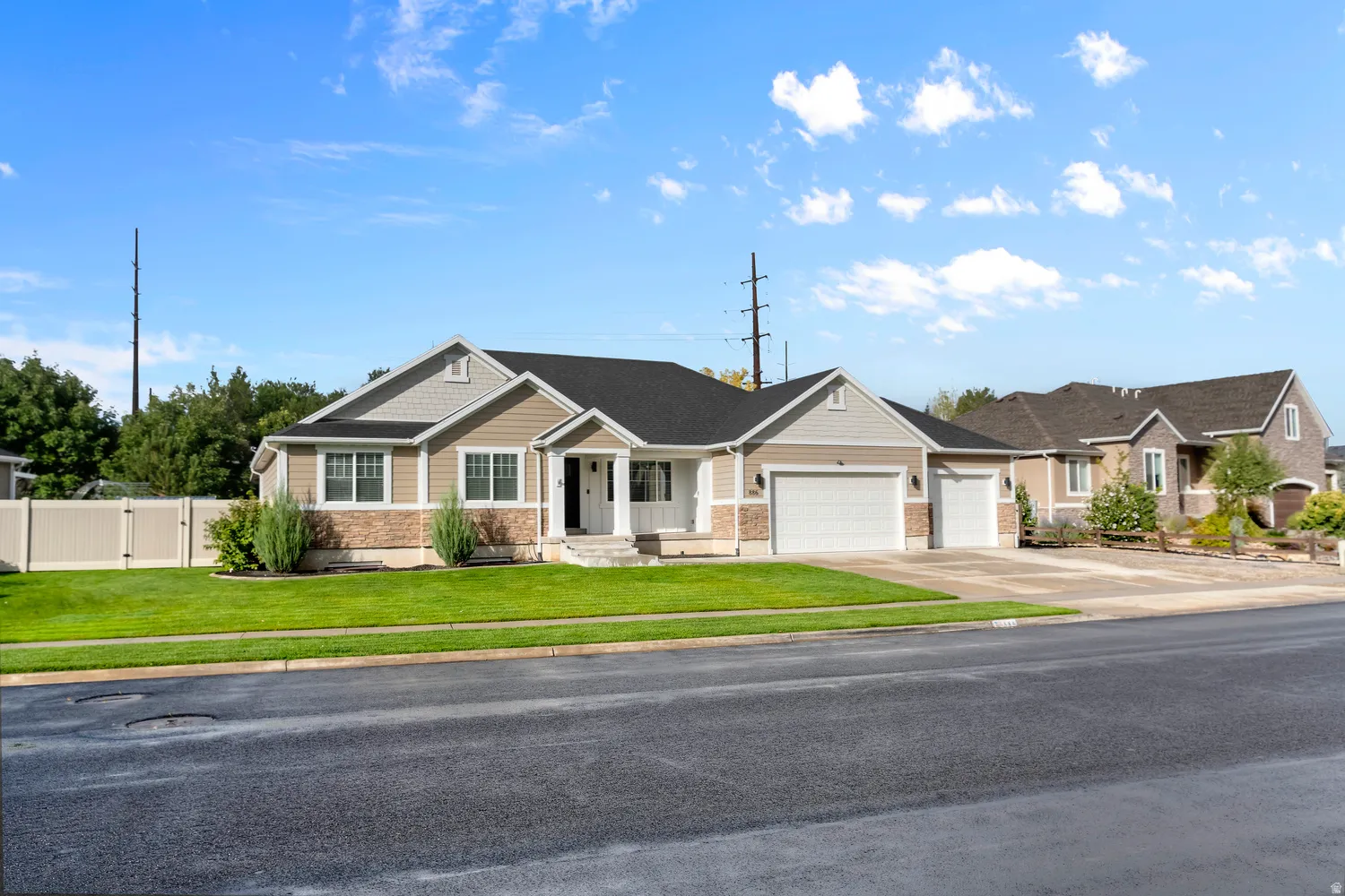 Single-story residence featuring a two-car garage, an additional one-car garage, and a covered entry