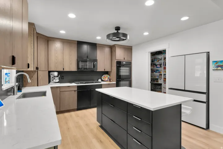 New kitchen features cabinets to the ceiling, double ovens, 5 burner gas cooktop, incredible fridge recessed in wall is included, Touchless faucet. huge pantry