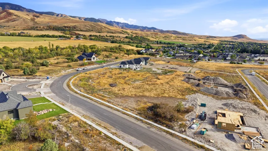 Mountain backdrop, established neighborhood, residential development, new construction, paved roads
