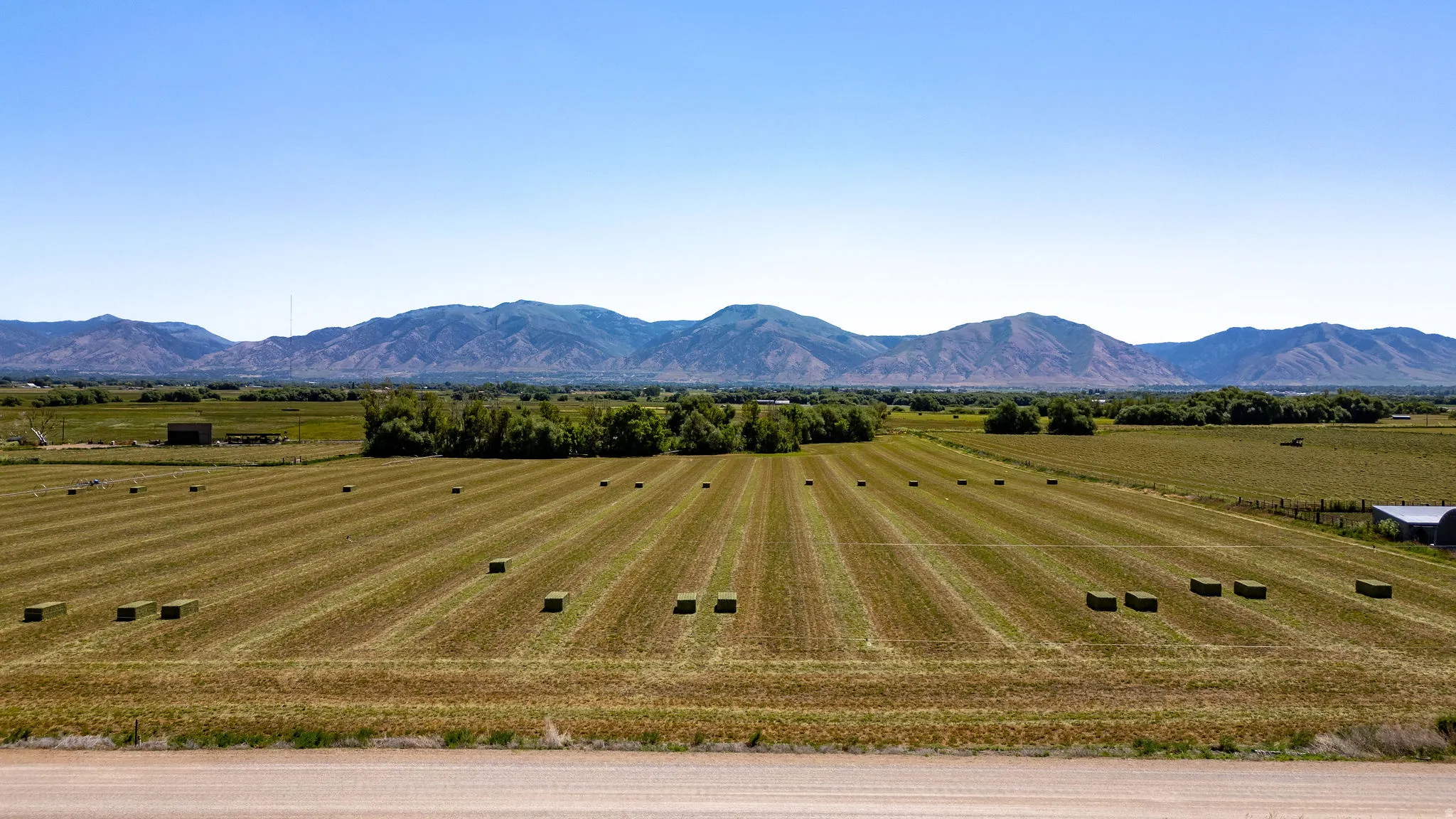 Expansive agricultural property featuring cultivated fields and a distant mountain range