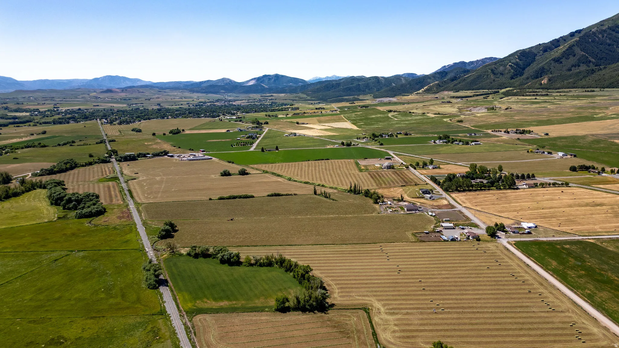 Expansive agricultural landscape featuring cultivated fields and a distant mountain range
