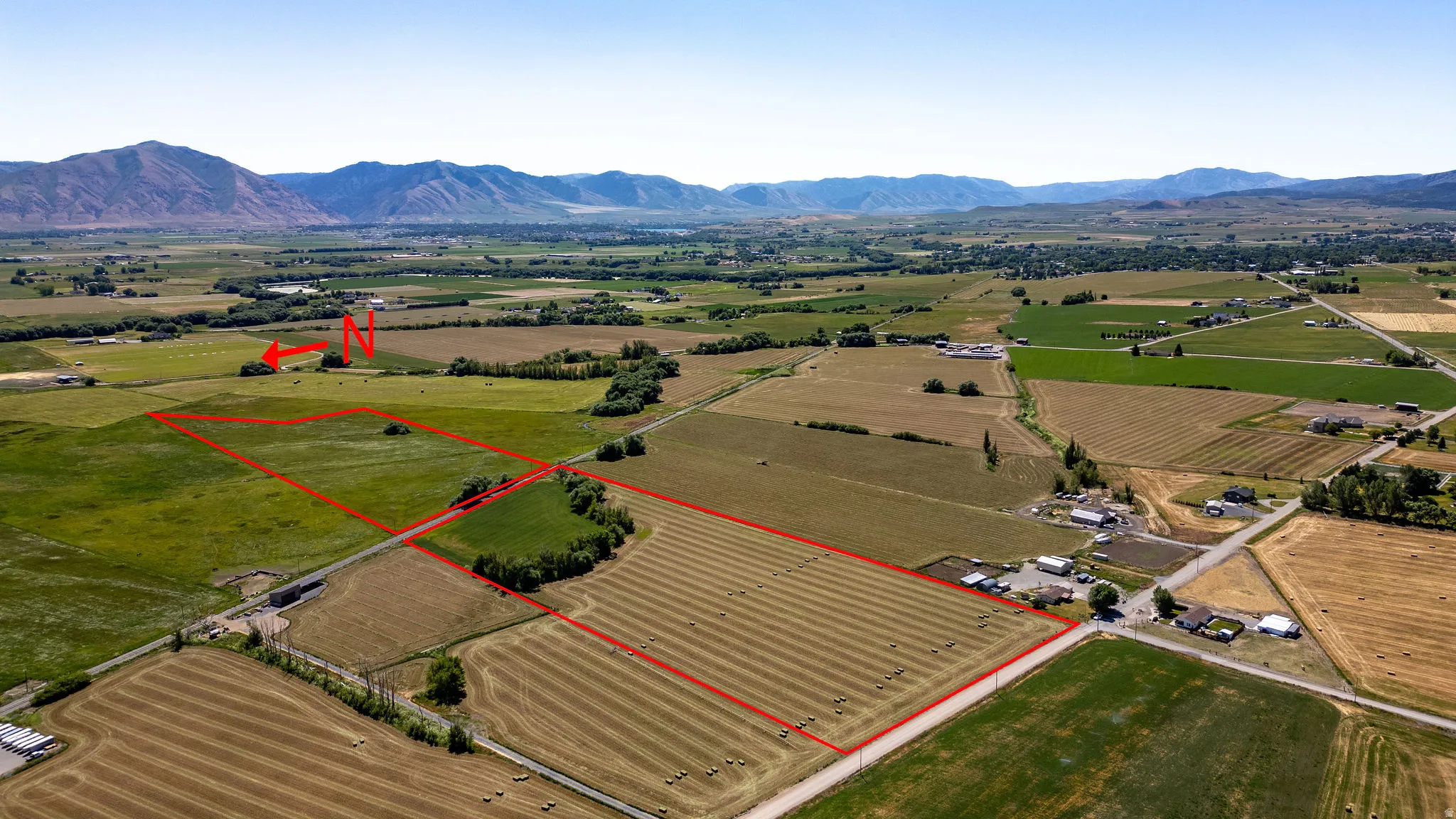Expansive agricultural land featuring fields and distant mountain ranges