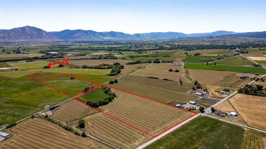 Expansive agricultural land featuring fields and distant mountain ranges