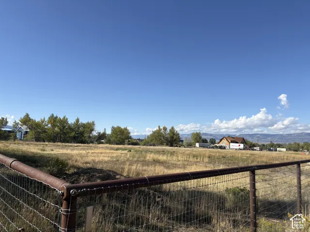 Expansive open land with a wire fence perimeter