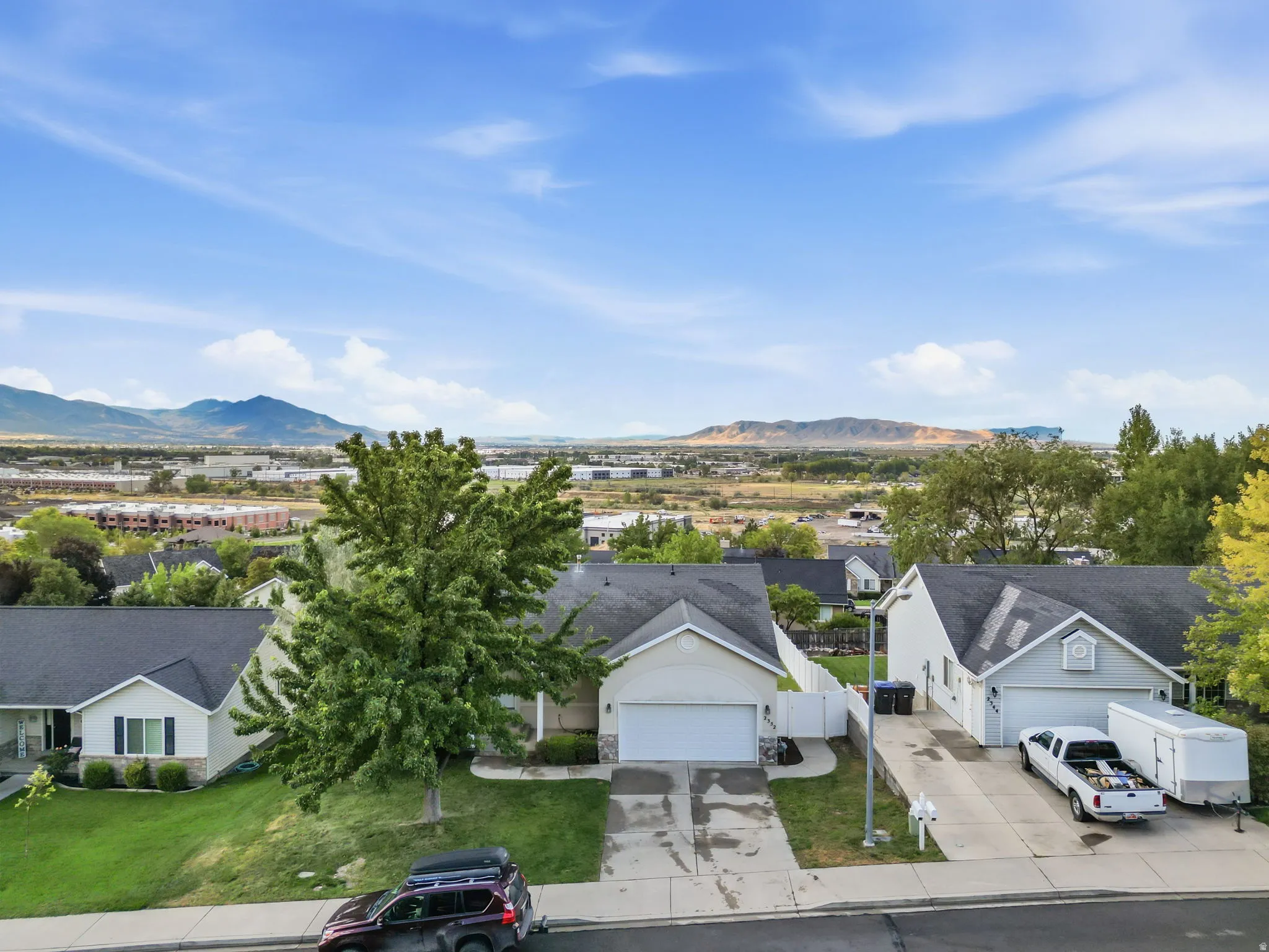 Suburban neighborhood setting with mountain backdrop and established landscaping