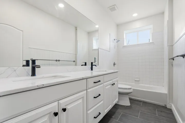 Dual sink vanity with white cabinetry and black hardware