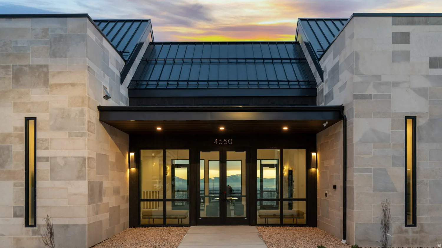 Stone veneer exterior with a metal standing seam roof