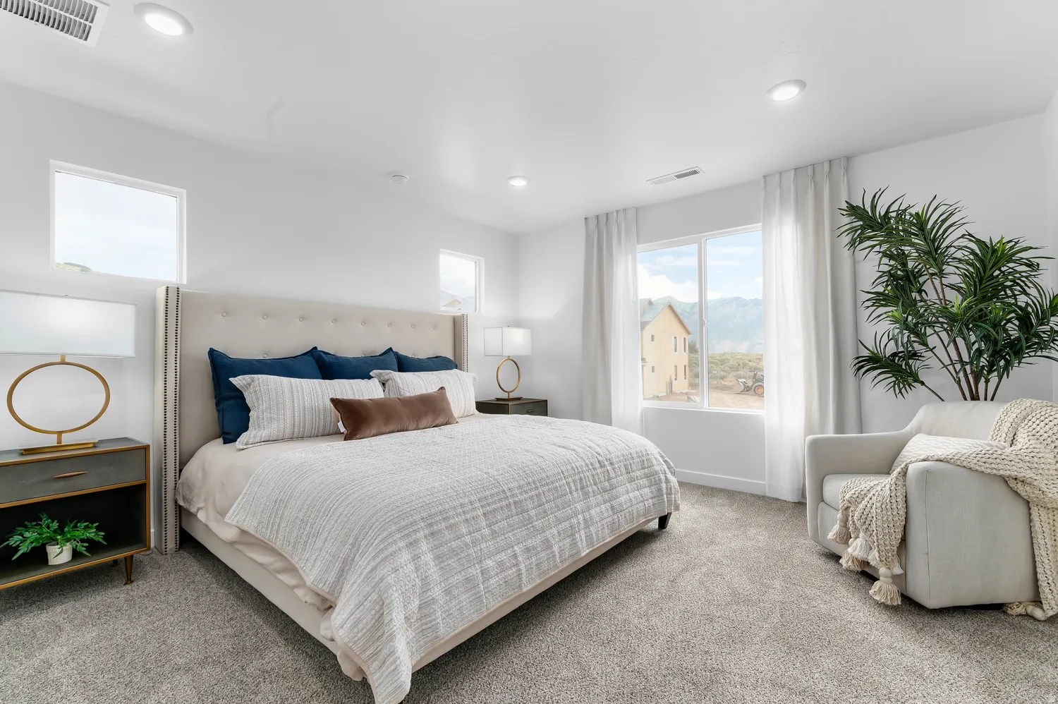 Recessed lighting, large windows, and a neutral color palette