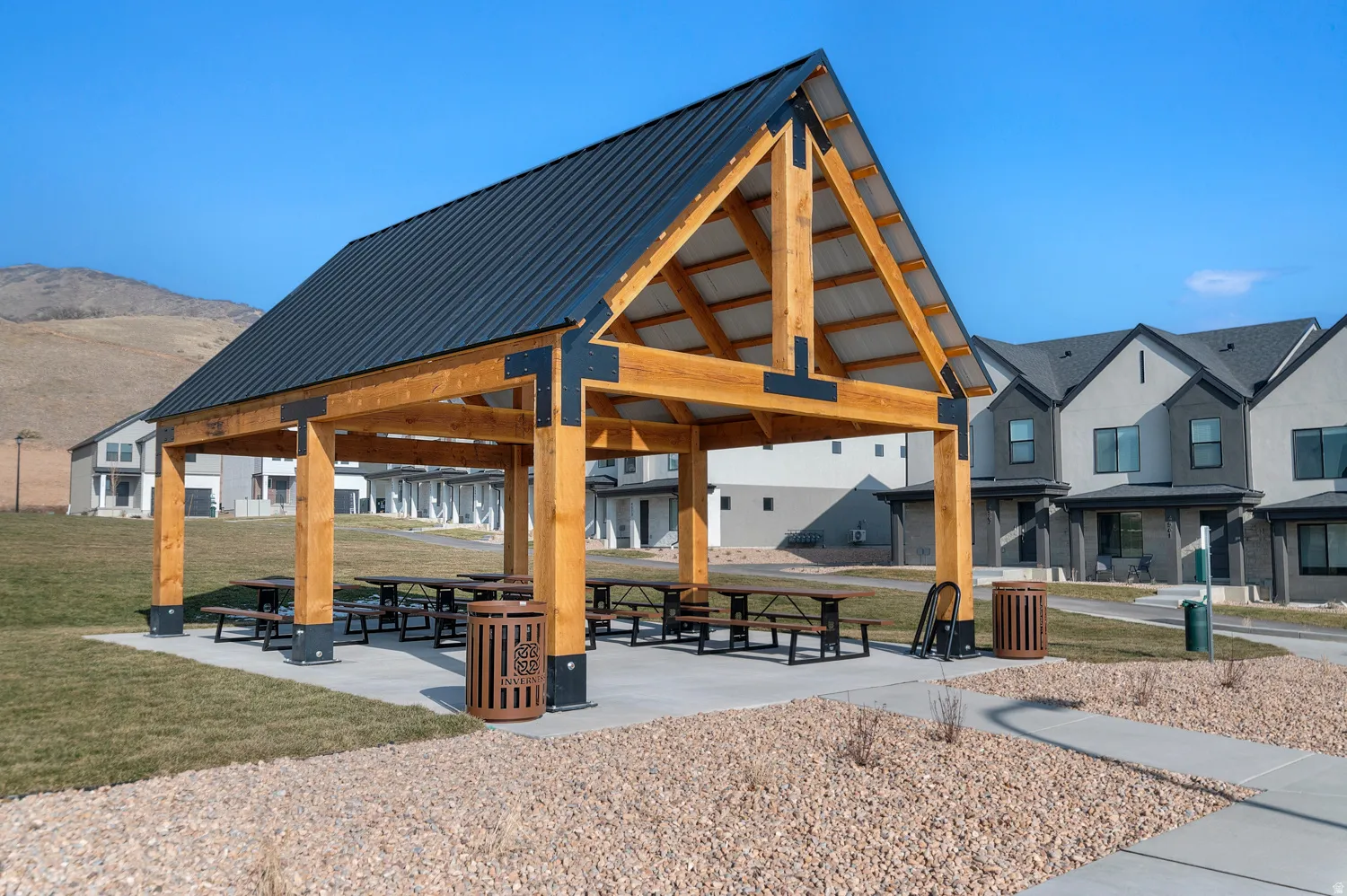Expansive outdoor pavilion with exposed timber framing and a metal roof