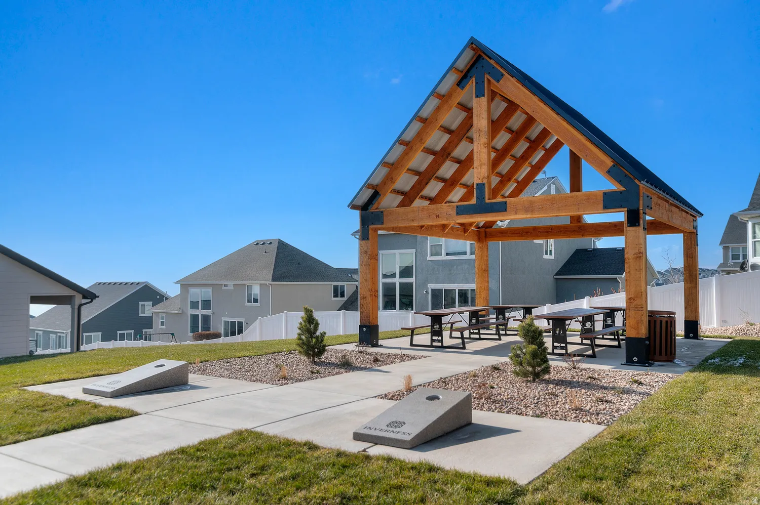 Open-air pavilion with exposed wood beams and black metal accents