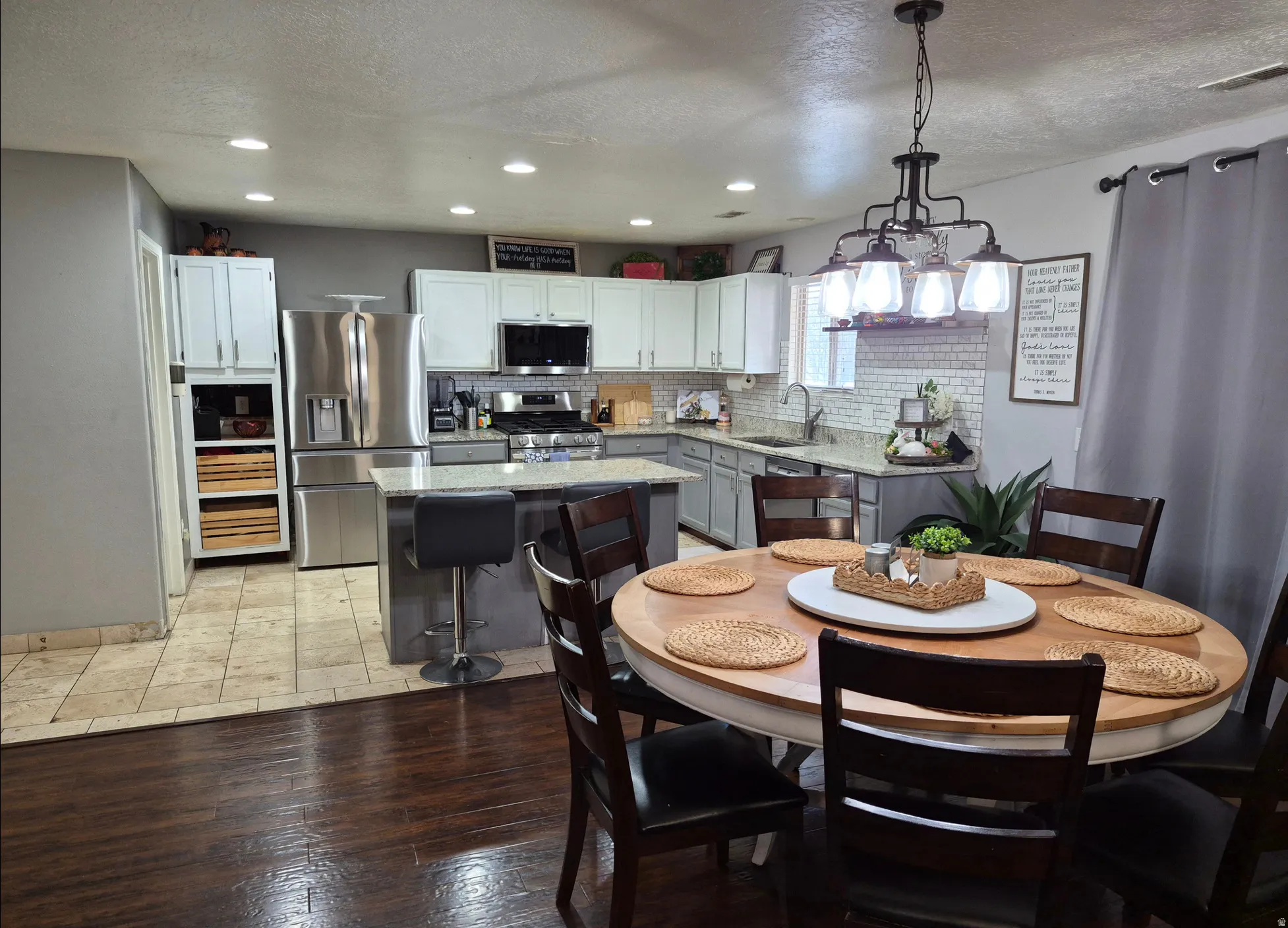 Kitchen featuring stainless steel appliances, granite countertops, tile backsplash, and recessed lighting