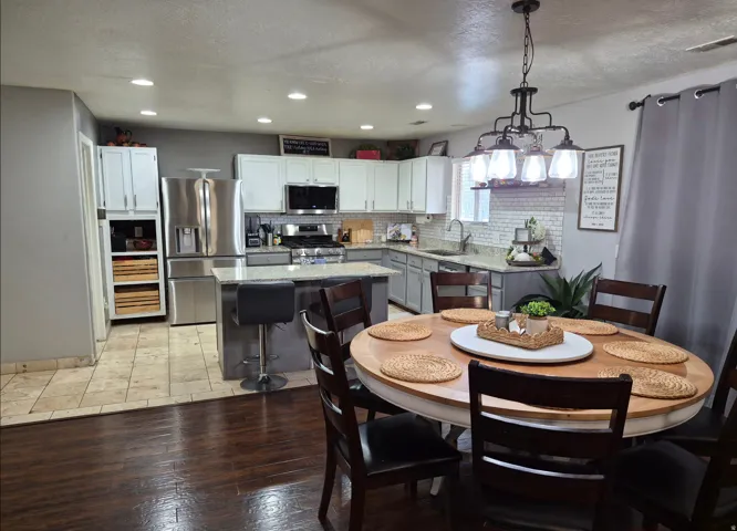 Kitchen featuring stainless steel appliances, granite countertops, tile backsplash, and recessed lighting