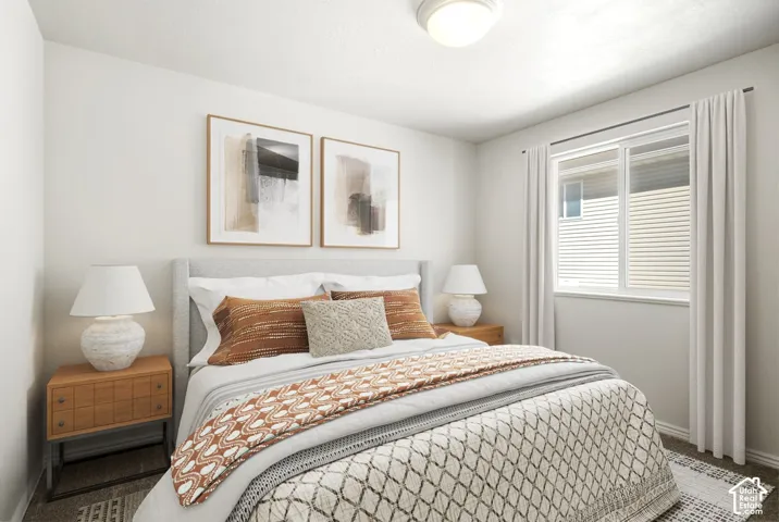 Recessed overhead lighting, textured carpet flooring, window with white blinds, neutral wall tones, and a built-in closet