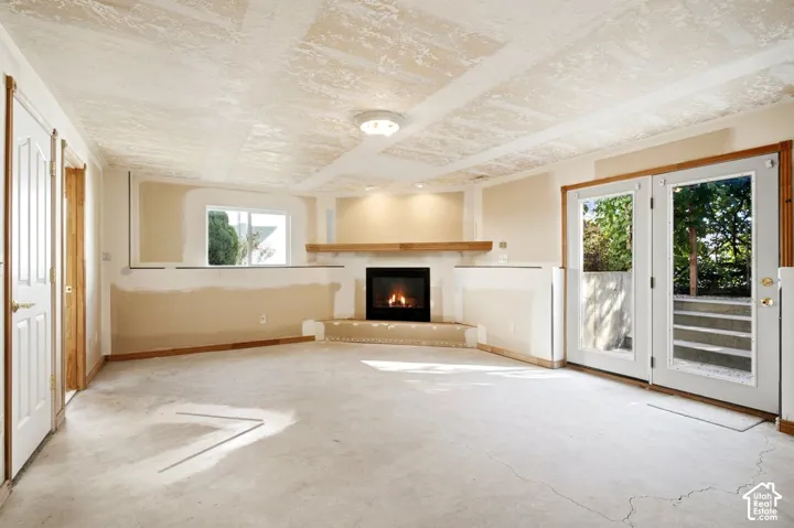 Partially finished basement family room. Fireplace with wood mantel