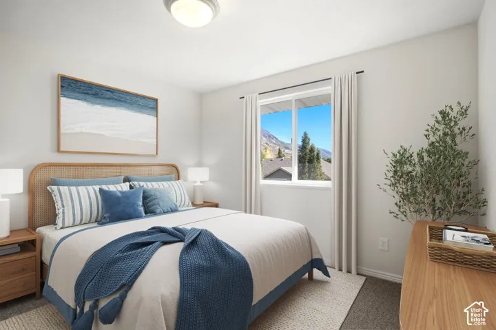Recessed ceiling light, large window, neutral wall paint, light-colored curtains, and gray carpeting