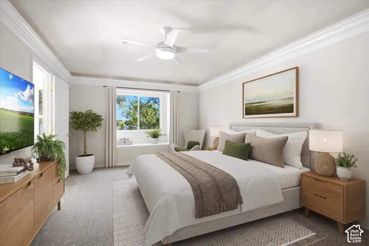 Vaulted ceiling with a ceiling fan, crown molding, large window with a built-in window seat, light-toned carpet flooring, and a light gray fabric bed frame