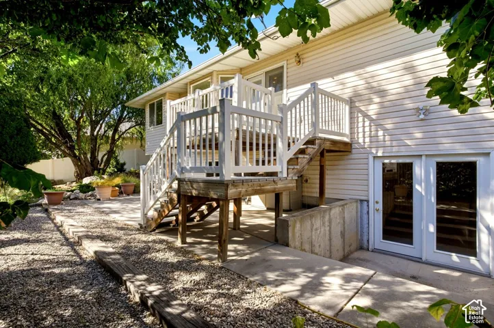 Raised wooden deck with white railings and staircase