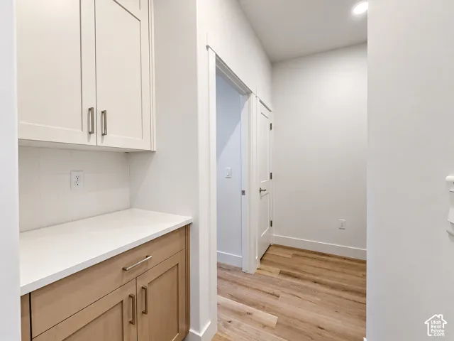 Two-tone cabinetry with light-toned wood-finish lower cabinets and white upper cabinets