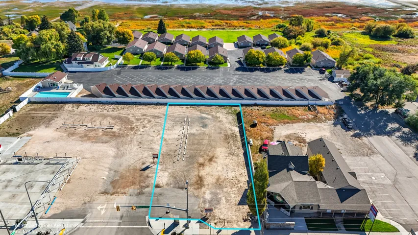 Expansive lot featuring street frontage, adjacent commercial buildings, and proximity to water