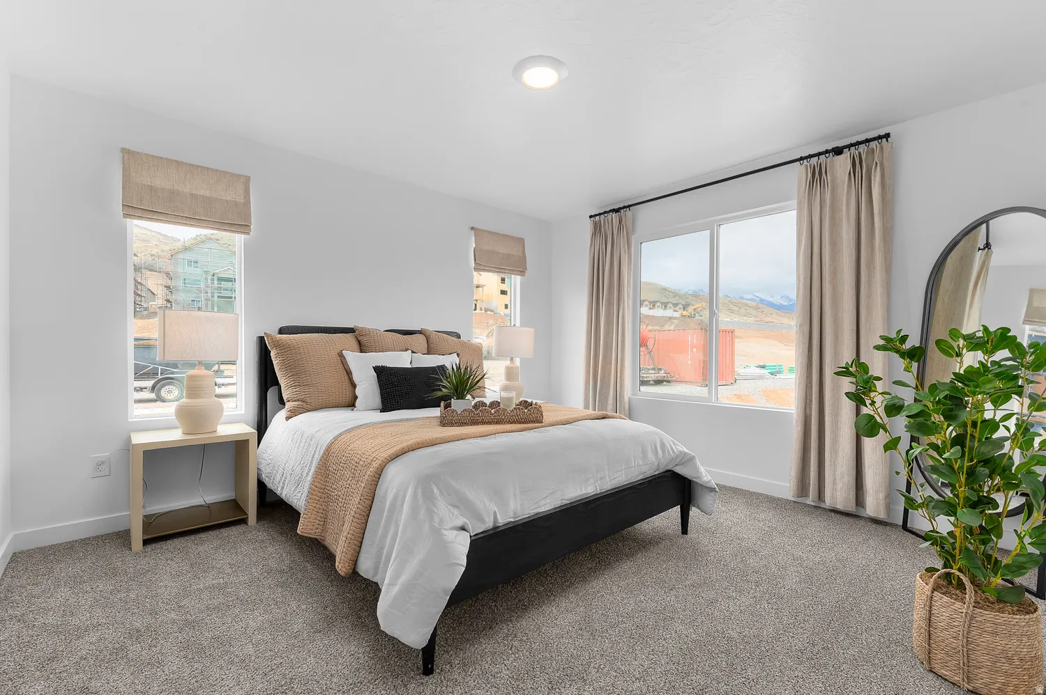 Recessed ceiling light, neutral wall colors, expansive window, neutral window treatments, and gray carpet flooring