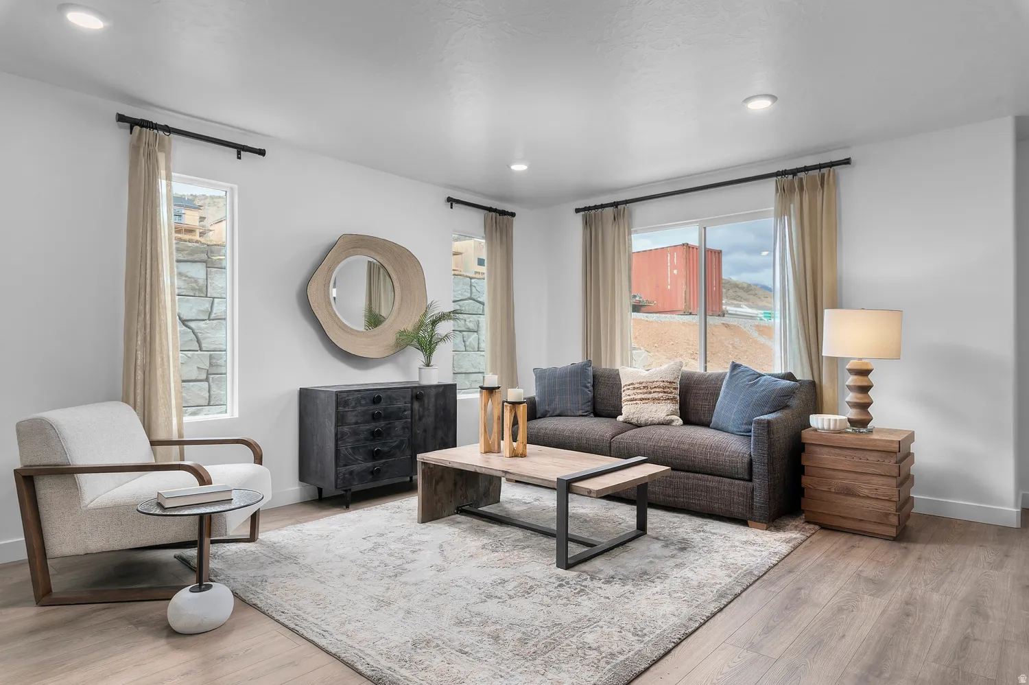 Recessed lighting, wood-finish flooring, and multiple windows with stone exterior elements