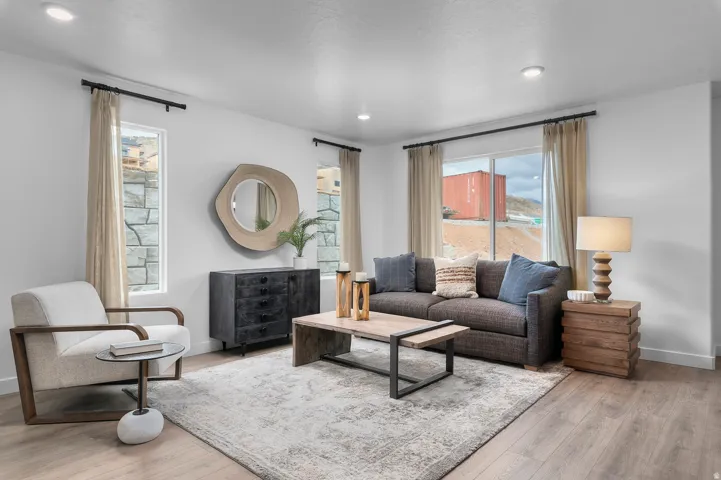 Recessed lighting, wood-finish flooring, and multiple windows with stone exterior elements