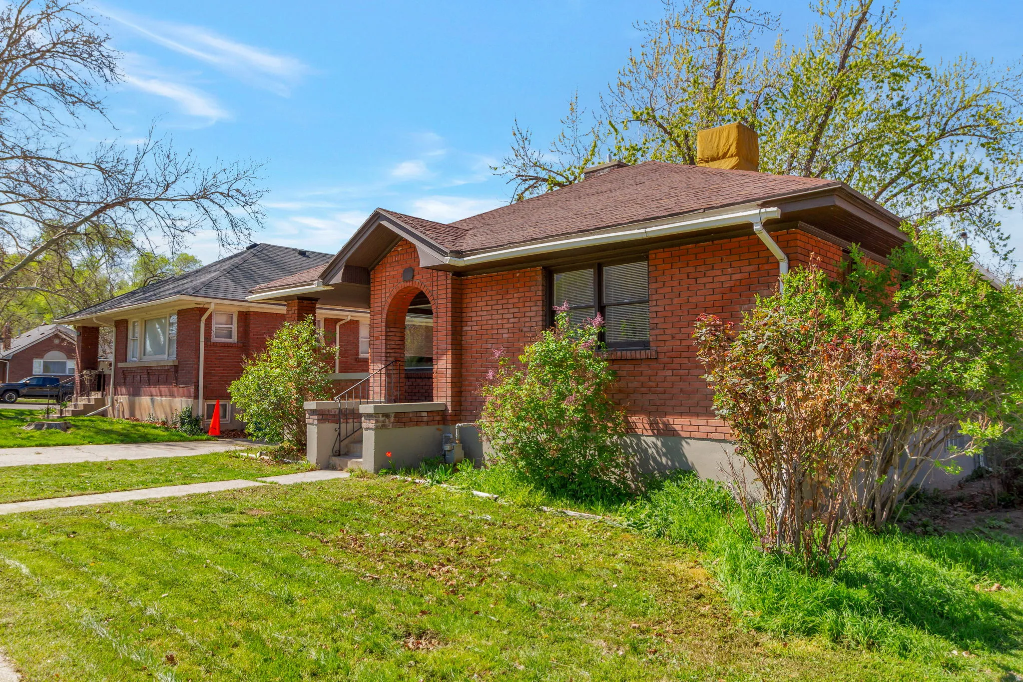 Brick exterior with a gabled roof and covered front entry