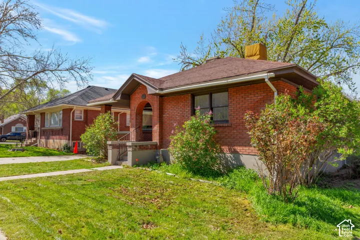 Brick exterior with a gabled roof and covered front entry