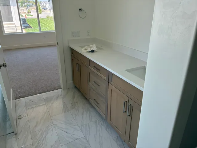 Dual vanity with integrated sinks and a light-toned countertop