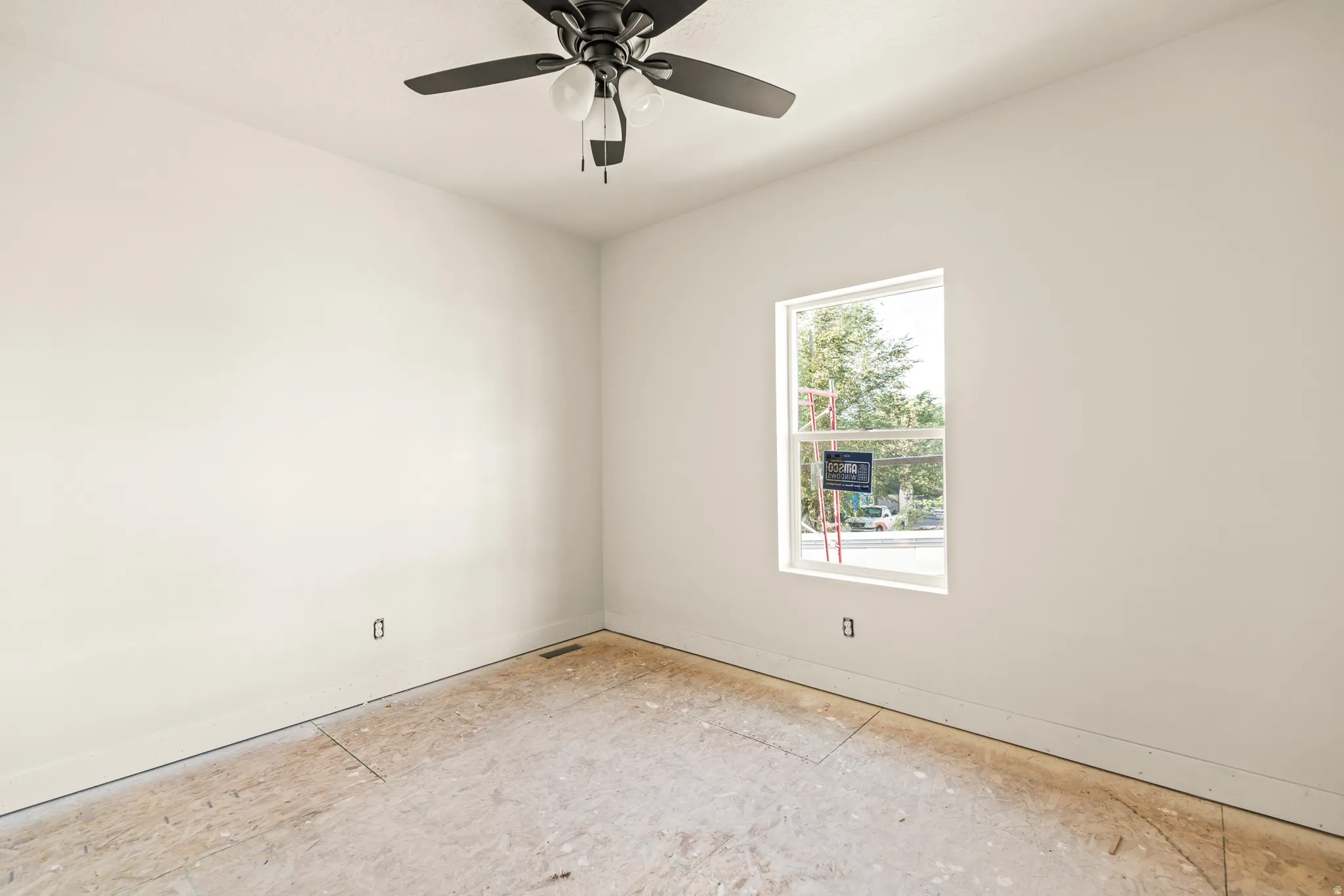 White painted walls, single window, and a ceiling fan with light fixture