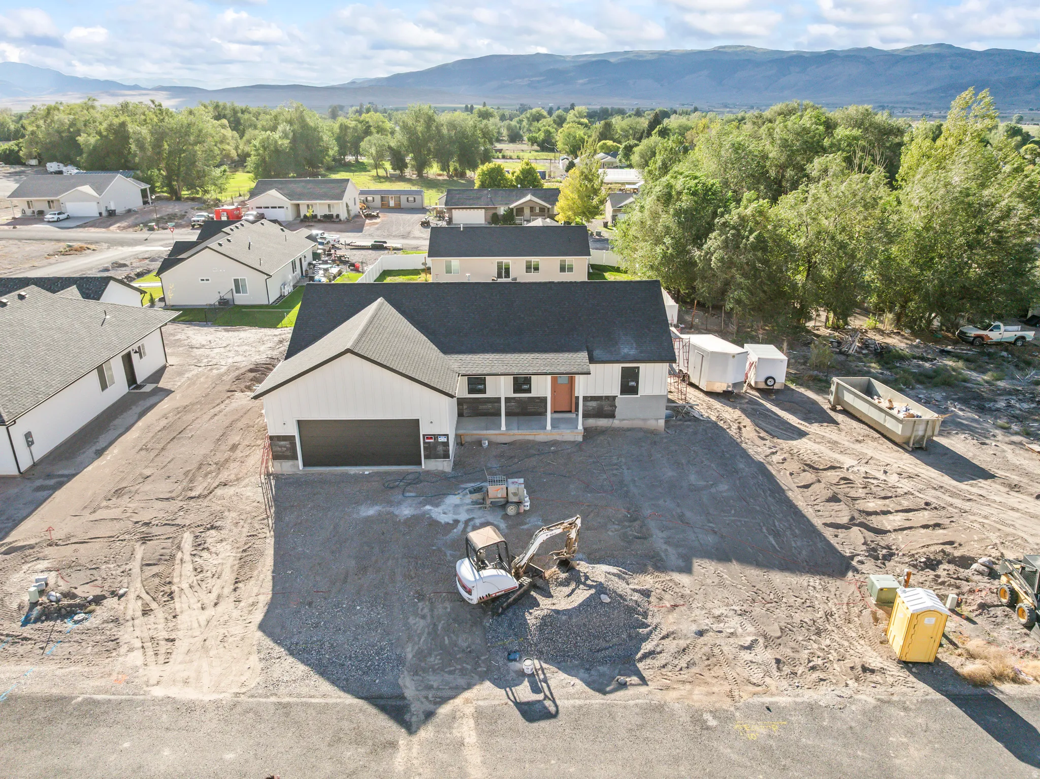 Newly constructed single-story residence with a dark shingle roof and a two-car garage
