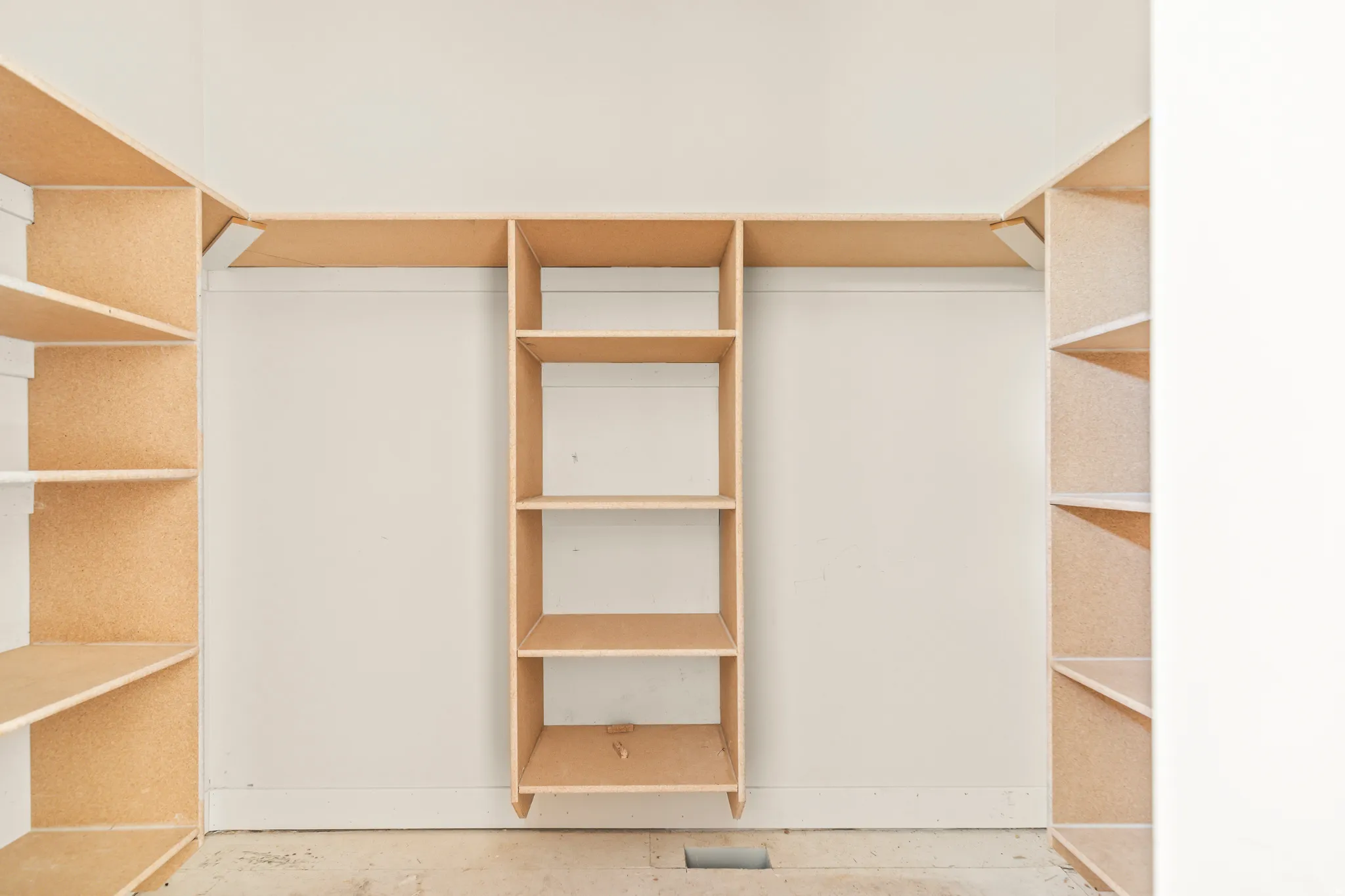 Built-in shelving system with vertical storage units and horizontal hanging rods