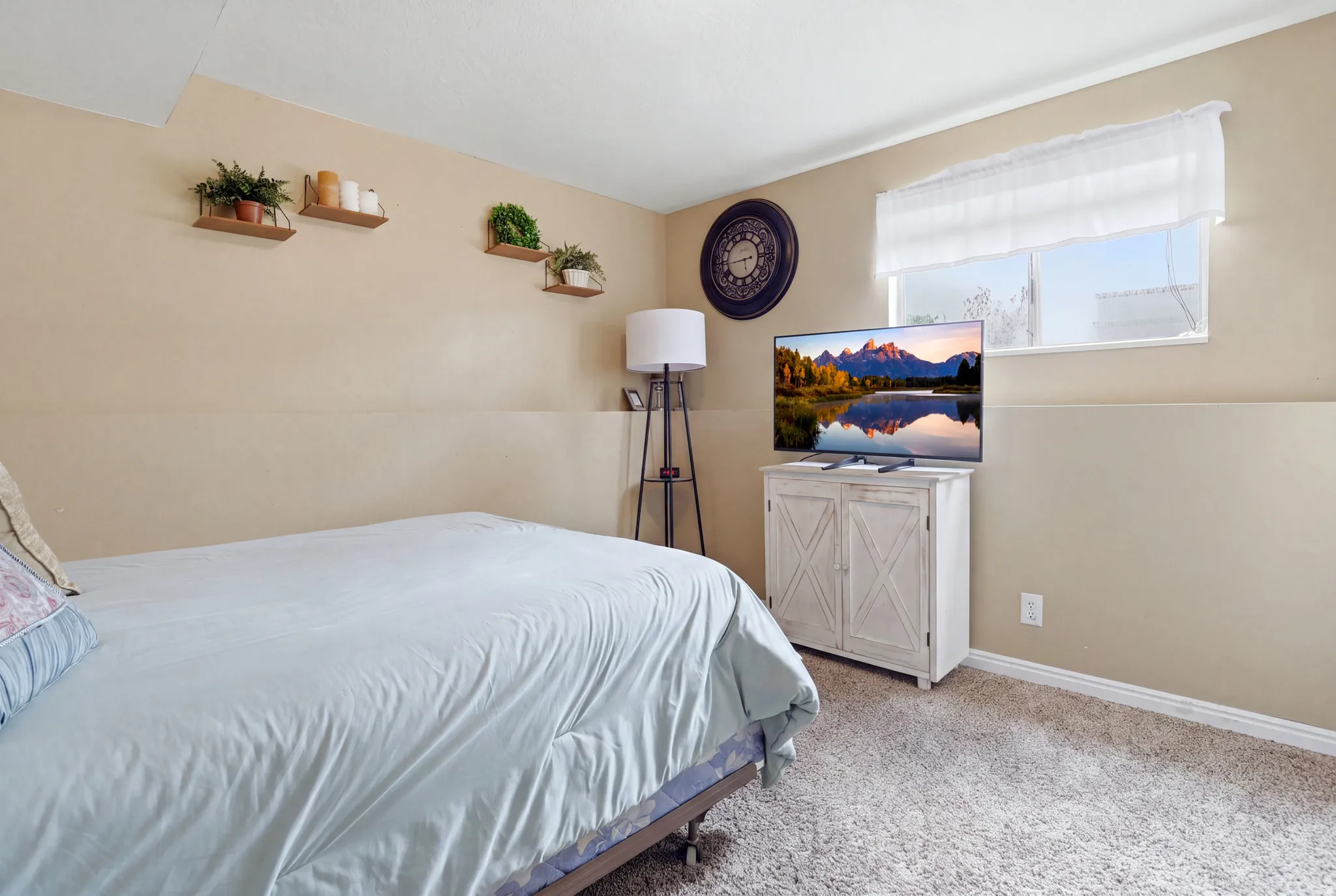 Recessed lighting, wall-mounted shelving, neutral wall paint, and white trim