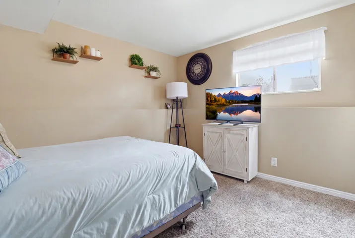 Recessed lighting, wall-mounted shelving, neutral wall paint, and white trim