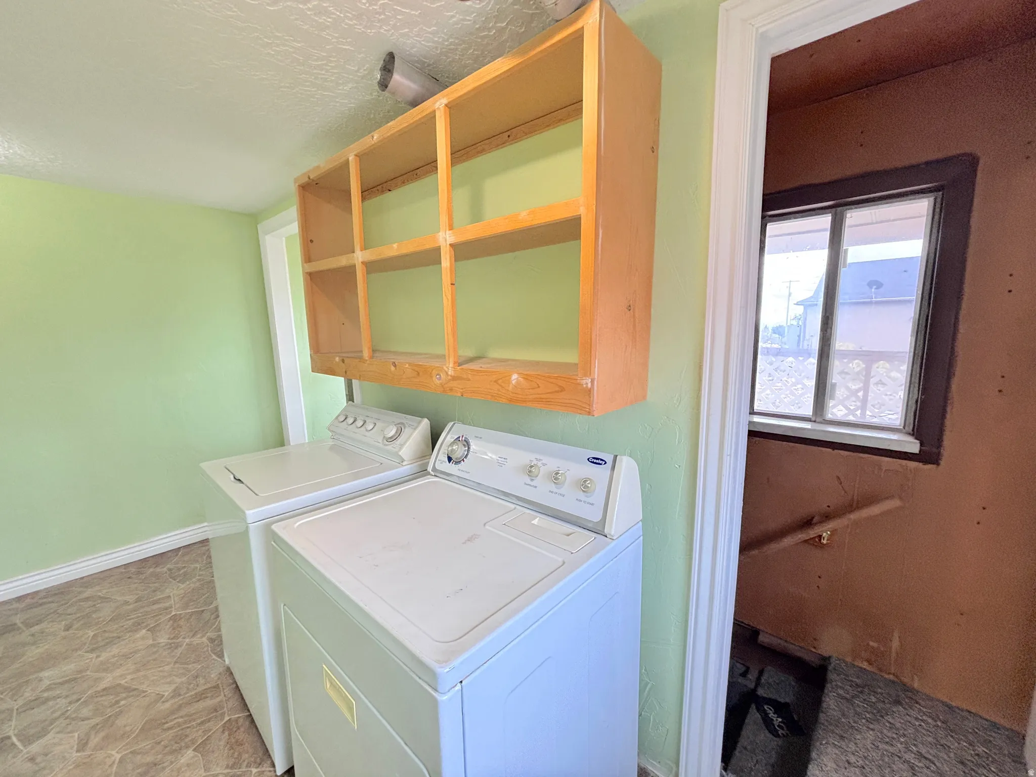 Open wood shelving above appliances