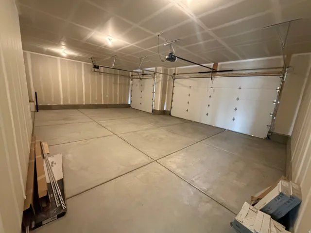 Bring in the cars and the toys.  High ceiling allows for some future storage. Garage doors are 8' high