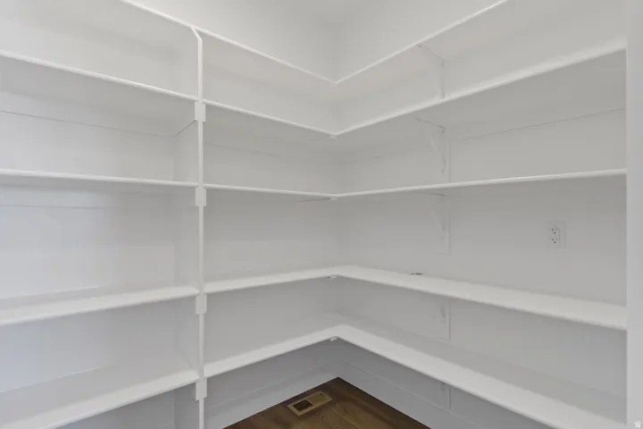 White built-in shelving with wood-finish flooring