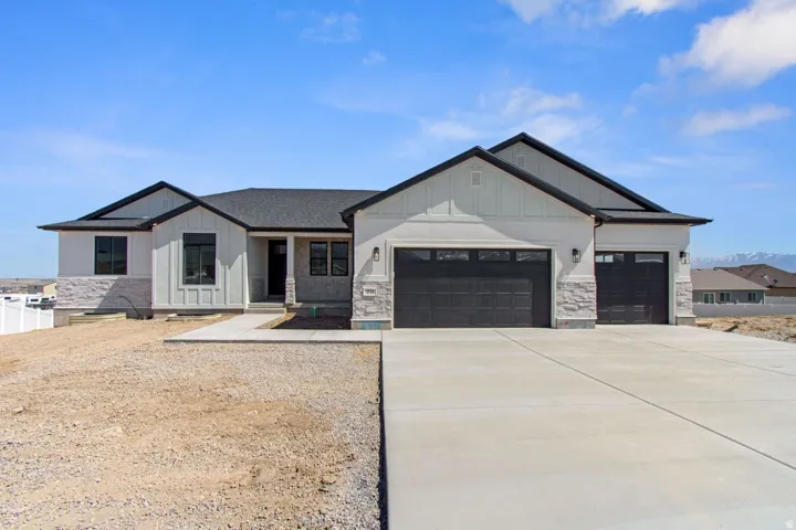 Contemporary exterior with board and batten siding and stone accents