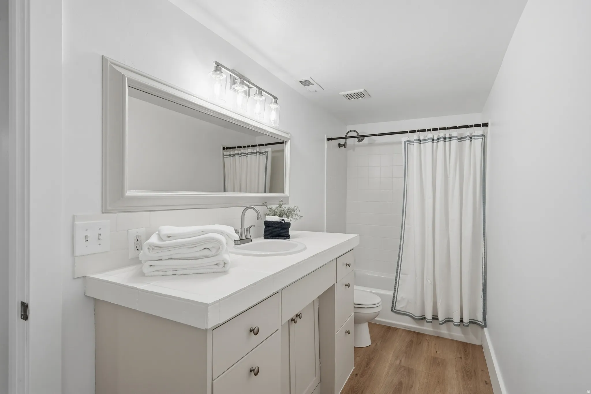 Bathroom with adult height vanity and tub/shower combo
