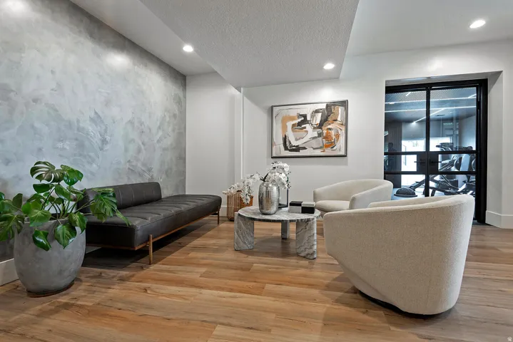 Wood-finish flooring, recessed lighting, and a textured accent wall