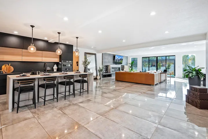Open-concept interior featuring large format tile flooring and recessed lighting