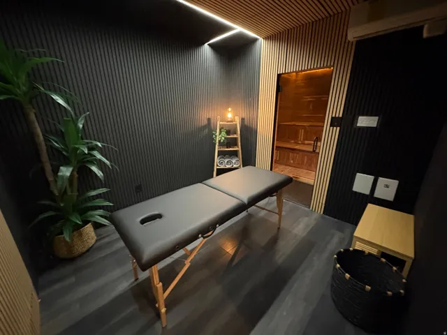 Massage room with large built in sauna in background