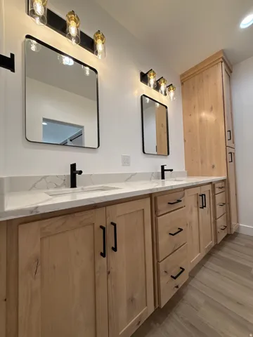 Dual vanity with quartz countertops, integrated sinks, and matte black fixtures