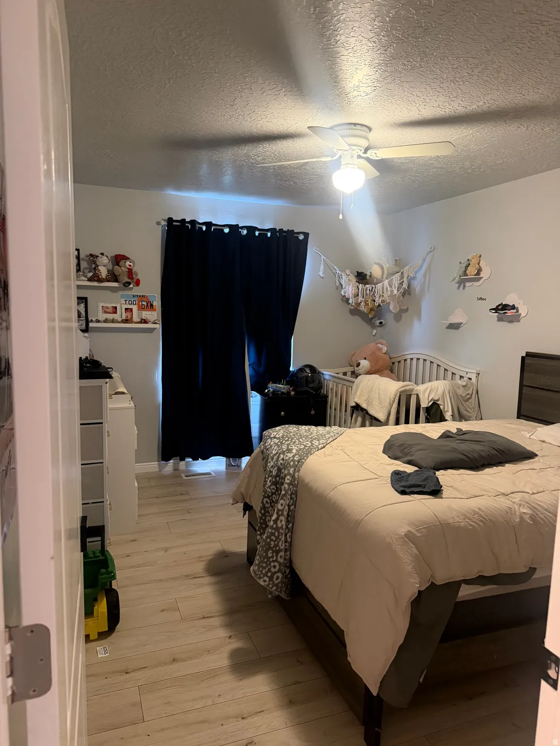 Wood-finish flooring with a ceiling fan light fixture