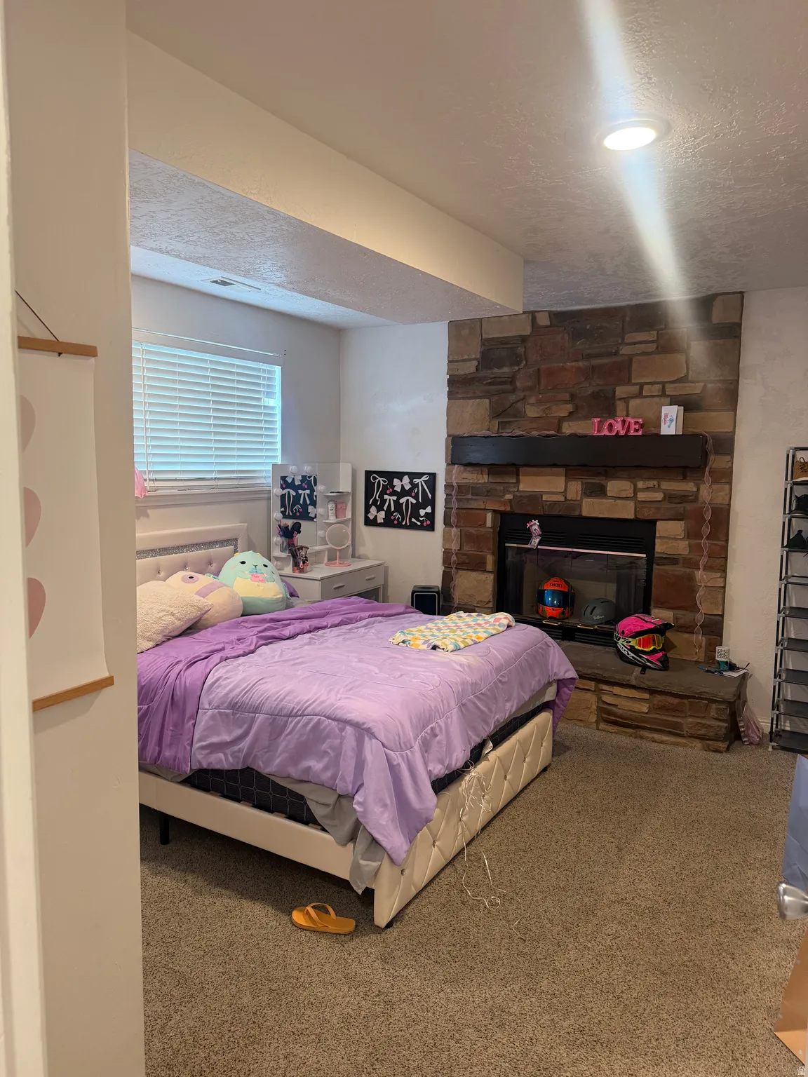 Built-in fireplace with stone surround and wood mantel