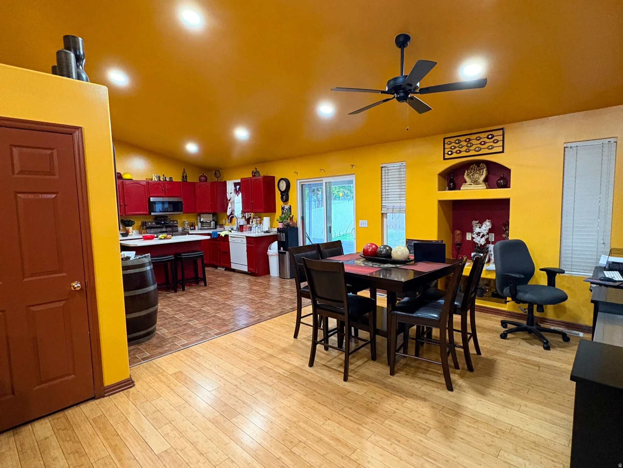 Wood-finish flooring, recessed lighting, and a ceiling fan