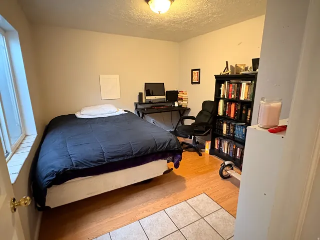 Recessed ceiling light fixture, wood-finish flooring, tiled entry, and neutral wall tones