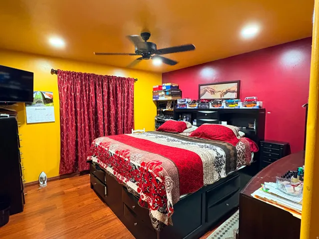 Wood-finish flooring, recessed lighting, and a ceiling fan with integrated light fixture