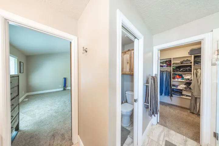 Primary suite walk-in closet is entered from the bathroom.